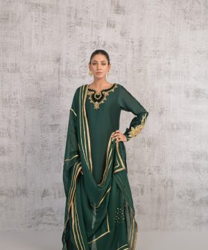 A woman wearing a green and gold dress
