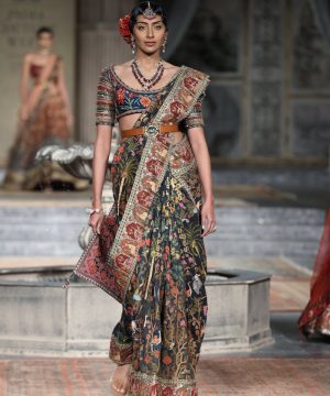 A fashion model in traditional attire on the runway in New Delhi, India.