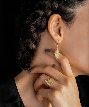 woman in gold diamond ring and black shirt