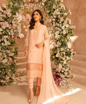 A woman standing in front of a floral arch