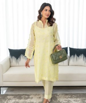 A woman standing in front of a white couch
