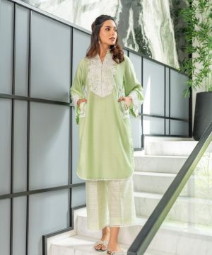 A woman in a green outfit standing on some stairs