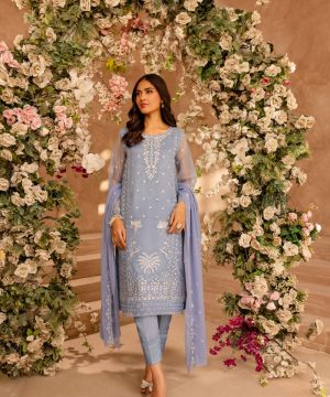 A woman standing in front of a floral archway