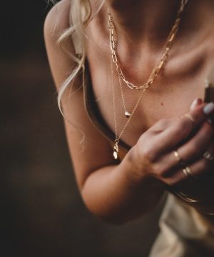 woman in white tank top wearing silver necklace