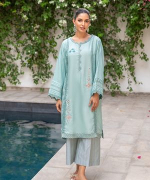 A woman standing in front of a pool