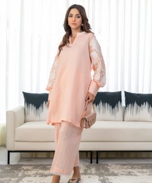 A woman standing in front of a couch in a living room