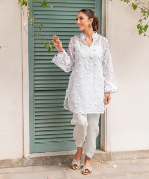 A woman standing in front of a green door