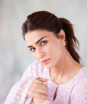 A woman in a pink dress is posing for a picture