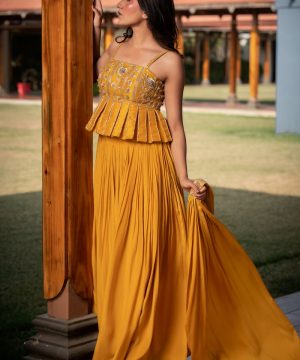 Woman in yellow peplum top and pleated skirt